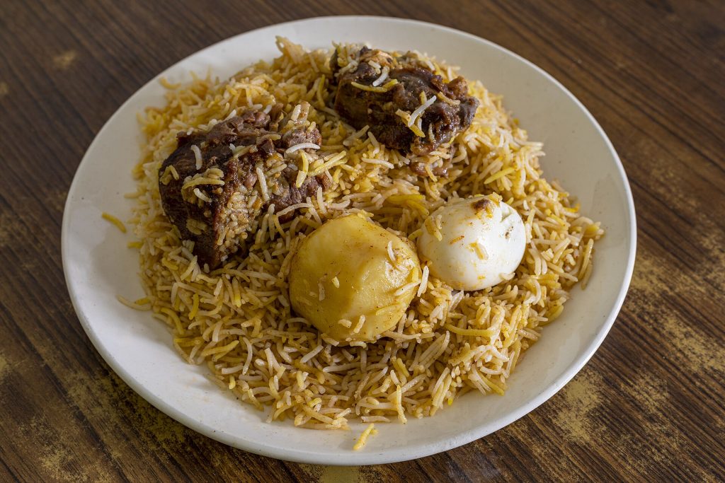 Kolkata style mutton biryani with a potato and boiled egg